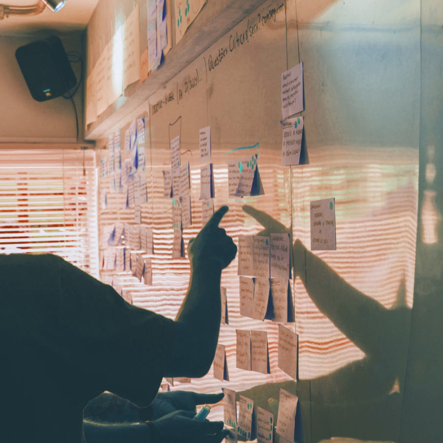 a man pointing at a whiteboard